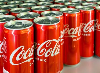 Voronezh - Russia, December 25, 2022: Background from cans with the drink "Coca Cola". (Shallow depth of field)