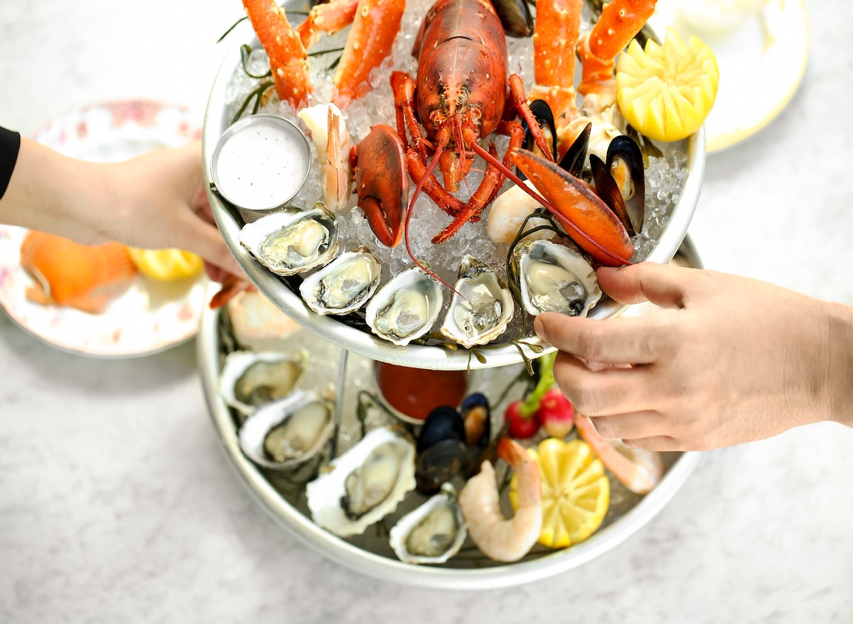 Seafood,Tower,Assortment,With,Hands,Grabbing,Items